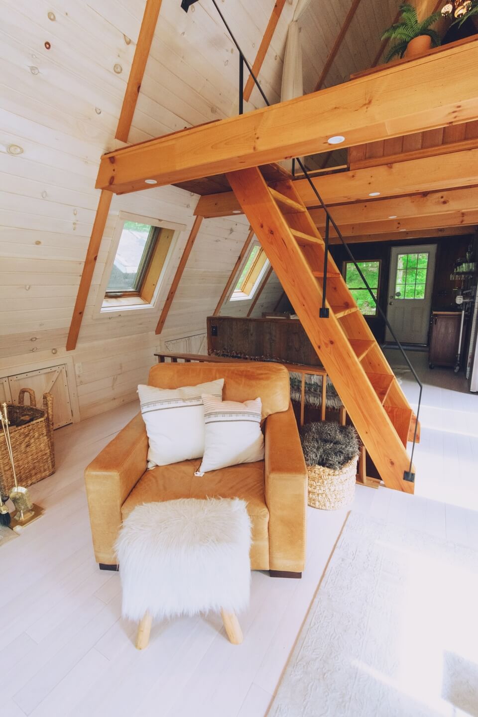 Comfy sofa with mechanic wooden stairs to attic