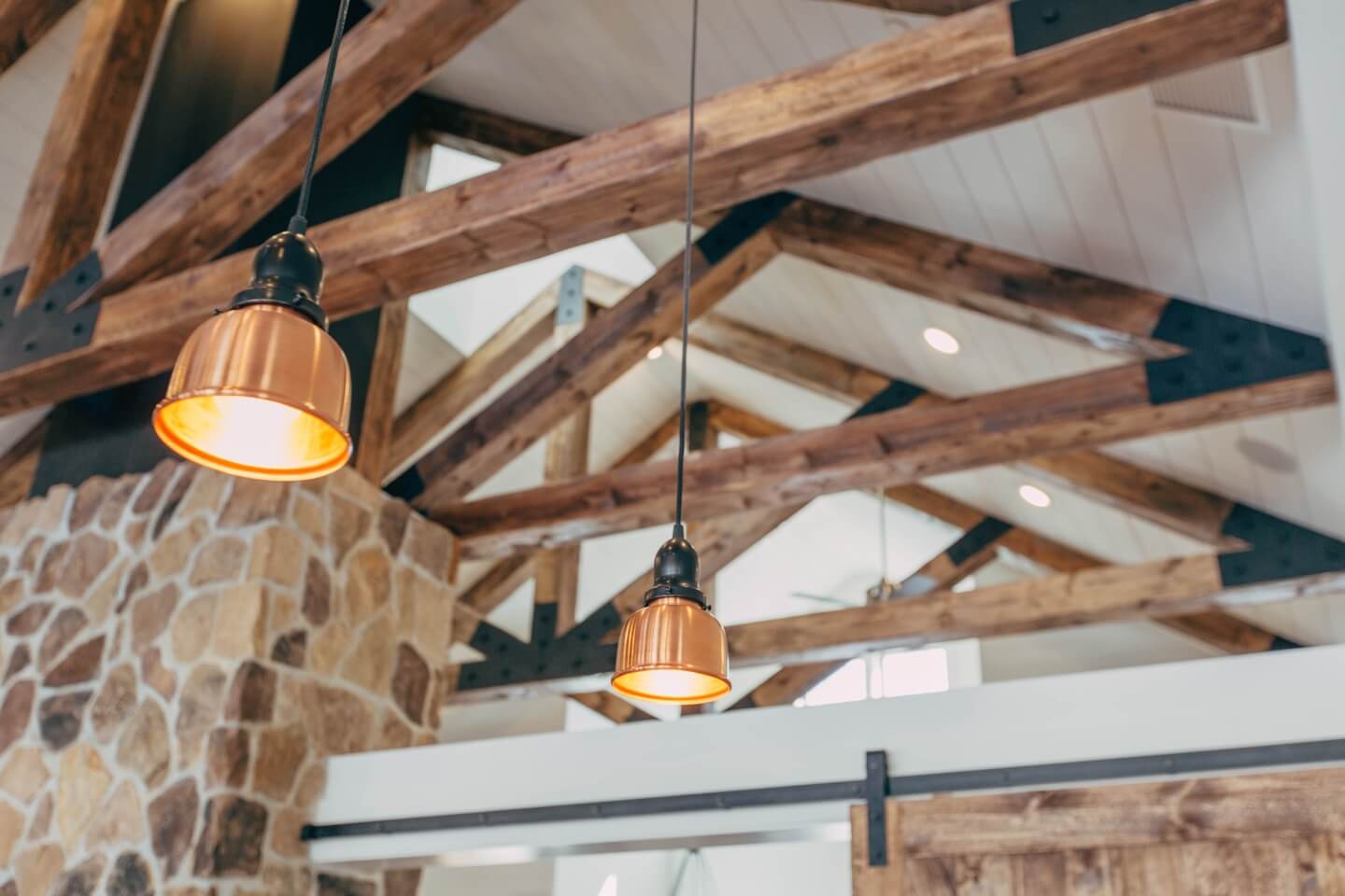 Lamps hanging from a dark brown wooden ceiling